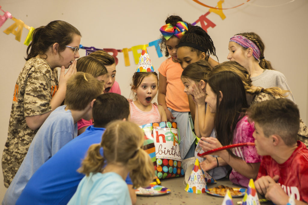 girl blowing out candles 